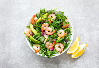 Shrimp arugula salad with avocado slices, high angle view of ready-to-eat dish