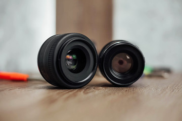 two black lenses on a wooden table
