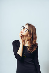 young woman thinking, daydreaming deeply about something chin on hand looking up