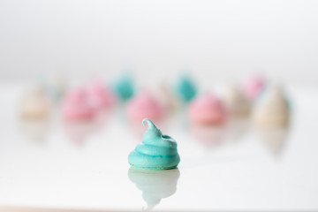 Meringue cookies on a white background. Sweet pastries. Assorted colors