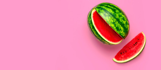 Creative summer food concept. Half and pieces of ripe juicy red watermelon on bright pink background. Flat lay, top view, copy space. Juicy Fresh Summer Berry
