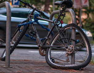 Fototapeta na wymiar Bicycle tied to a street light and smashed in the street