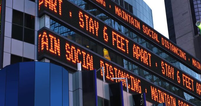 A Times Square stock market ticker reminds pedestrians to keep 6 feet apart from each other. Social distancing was a common practice to slow down the spread of COVID-19 during the pandemic of 2020.	