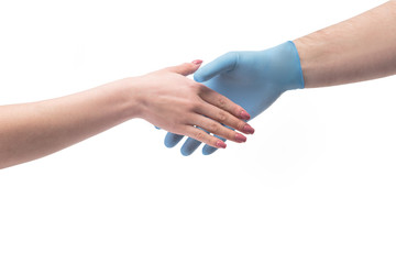 Hand in gloves shaking hand without gloves close up