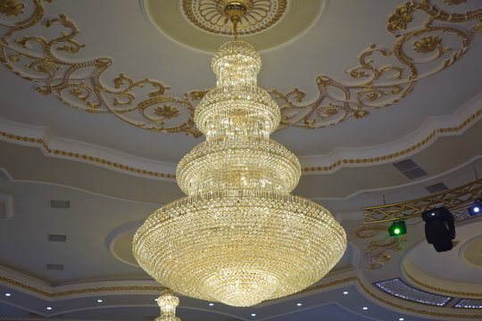 illustration of a chandelier with crystal pendants on the black . Palace ball hall for dancing, ballroom . Big and old expensive crystal chandelier .