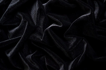 Velvet background. Velvet is black. Beautiful fabric. Abstract background