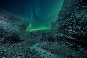 Northern lights aurora borealis over glacier ice caves in Iceland
