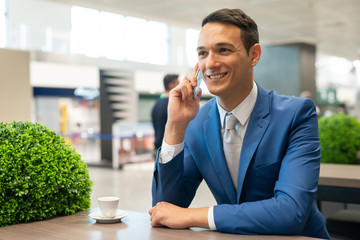 Man talking on the phone in a cafe