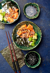 Salmon sushi bowl or salmon poce with soy sauce. Top view.