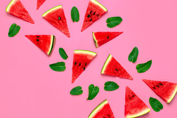 Creative summer food concept. Watermelon pattern. Juicy slices of ripe red watermelon and mint leaves on pink background. Flat lay, top view, copy space. Juicy Fresh Summer Berry