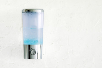 Hand Sanitizer Jel Dispenser Mounted on White Plaster Wall for Hand Hygiene for Corona Virus Protection