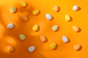 Easter eggs on the orange background closeup copy spase