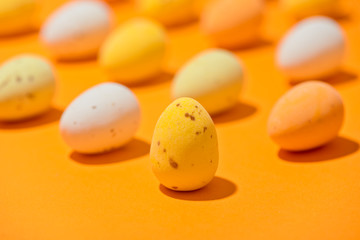 Easter eggs on the orange background closeup copy spase