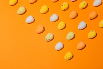 Easter eggs on the orange background closeup copy spase
