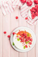 Cheesecake with fresh raspberries and plums