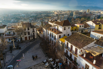 Fototapeta premium Granada, Spain - February 11th, 2019 : Overview of the San Miguel Bajo square at the Unesco listed Albayzin district with modern city in background.