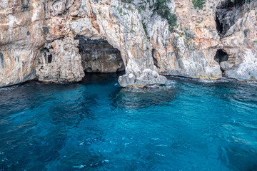 Natural caves in gulf of Orosei with turquoise water