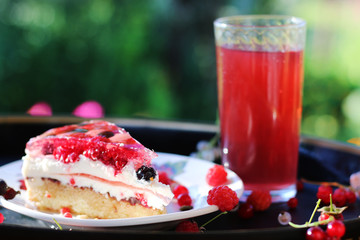 cake with berries outdoor with berries juice. spring green blackberry strawberry biscuit cake outdoor party