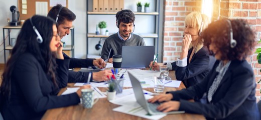 Group of call center workers smiling happy and confident. Working together with smile on face using headset at the office.