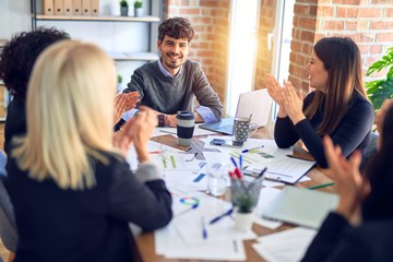 Group of business workers smiling happy and confident. Working together with smile on face applauding one of them at the office