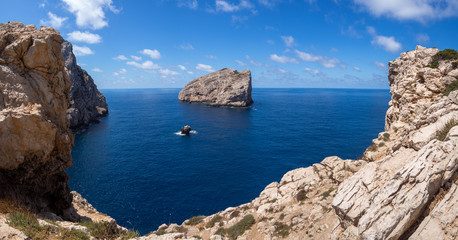 Views of the coast of Sardinia with a big rock in the sea