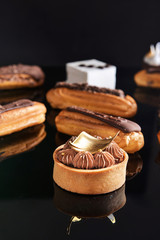 Tasty cakes on dark background