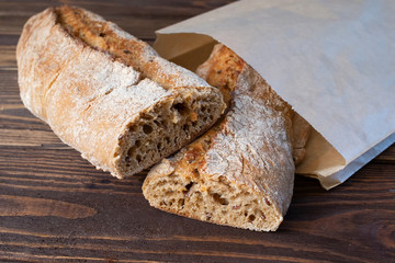 Baguettes brown on wooden background. French bread.