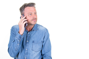 Attractive handsome man talking on smartphone phone and looking aside away isolated on white background