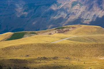 Road in the crater of Nemrut volcano, Bitlis Province, Eastern Turkey. Golden fields, hills and mountains. Beautiful landscape. Panoramic view of the volcano Nemrut.