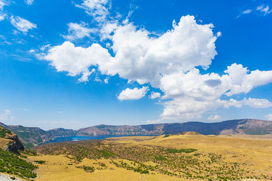 Panoramic view of Nemrut crater lake, Bitlis Province, Eastern Turkey. Beautiful blue lake and dramatic sky. Amazing mountain landscape