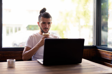 Handsome Turkish man with curly hair relaxing at the coffee shop