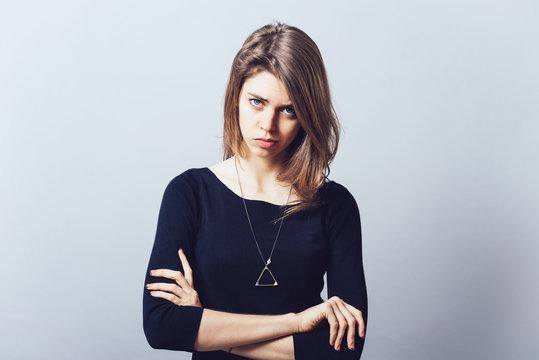 Closeup portrait displeased pissed off angry grumpy pessimistic woman with bad attitude, arms crossed looking at you Negative human emotion facial expression feeling
