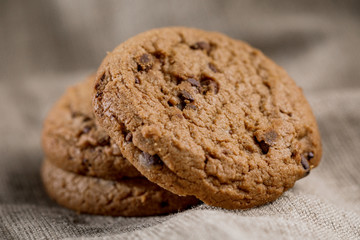 Chocolate cookies on a linen napkin on a wooden table