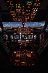 Dramatic Full view of cockpit modern Boeing aircraft before take-off. Airplane is ready to fly. Night shot in cabin. Safety flight - 338537260