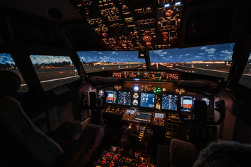 Dramatic Full view of cockpit modern Boeing aircraft before take-off. Airplane is ready to fly. Night shot in cabin. Safety flight - 338537484