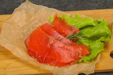 Sliced salmon fillet served rosemary