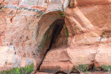 Cave in red sandstone cliff 