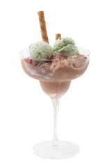 Smooth frozen treat concept with mixed green (mint or pistachio) and brown (chocolate) melting ice cream in transparent glass cocktail cup isolated on white background with clipping path cutout