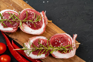 Raw beef steak on a dark wooden table