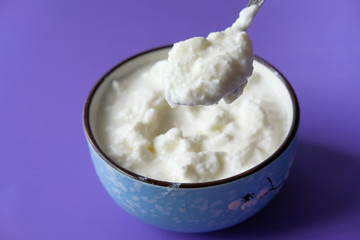 bowl of fresh yogurt on table, close up.