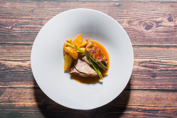Roasted veal with fried potato served on a restaurant table