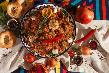 Dishes of Uzbek cuisine on a red background and beautiful decoration.