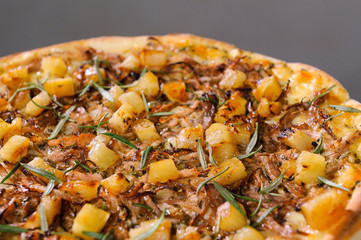Goat meat pizza with pineapple and rosemary.
