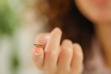 Young African-American woman with contact lens at home, closeup