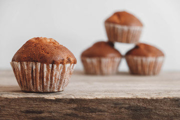 Chocolate cupcakes on wooden table background. Copy, empty space for text