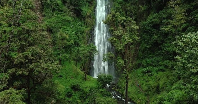 Big waterfall surrounded by green hills and jungle, aerial shot at Materuni village, Kilimanjaro Mountain, Tanzania