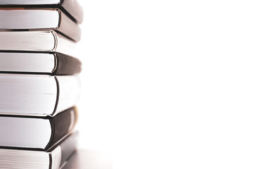 Stack of books with shallow depth of field on a white background. With copy space.