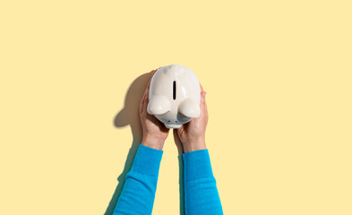 Person holding a piggy bank from above