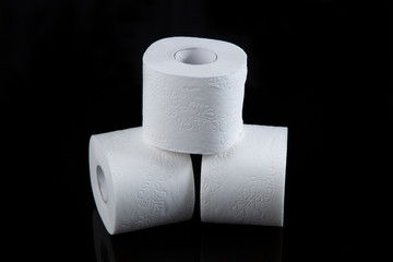 Toilet paper is white on a black background. Hygiene products.