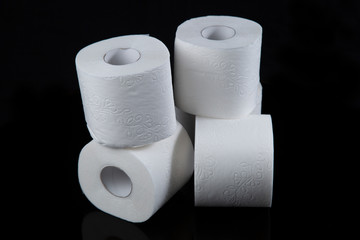 Toilet paper is white on a black background. Hygiene products.
